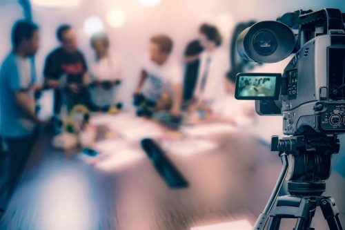 video-camera-taking-live-video-streaming-people-working-background-scaled.jpg Unique combination of creative and technical teams